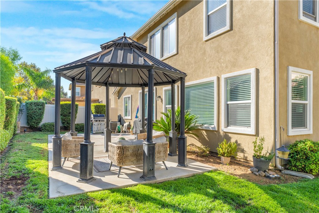 35814 Anderson Street Beaumont, CA 92223 - Photo 66 of 75 a view of a patio with a table chairs under an umbrella