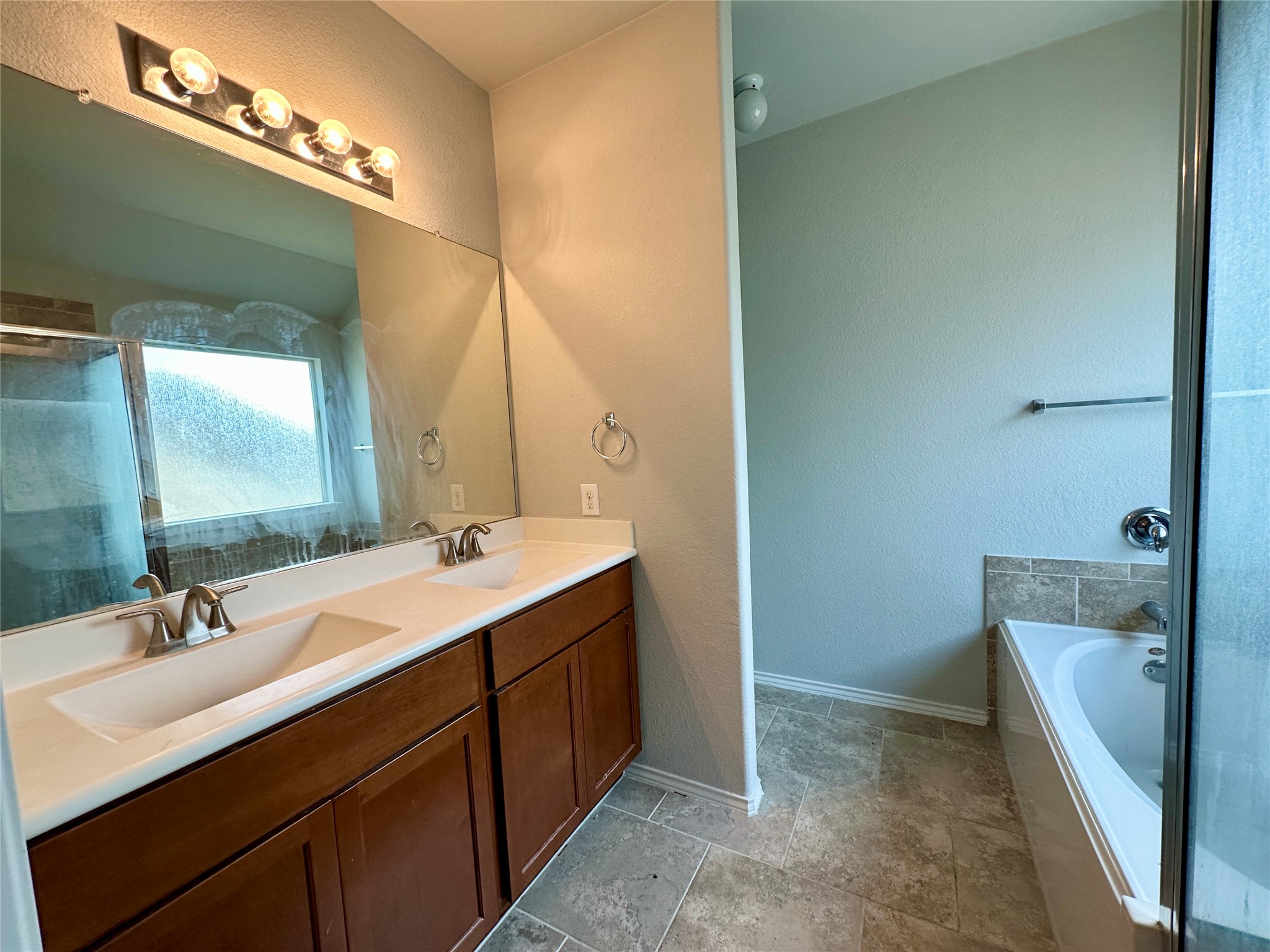 117 Chickadee Lane Leander, TX 78641 - Photo 14 of 24 a bathroom with a double vanity sink and a mirror