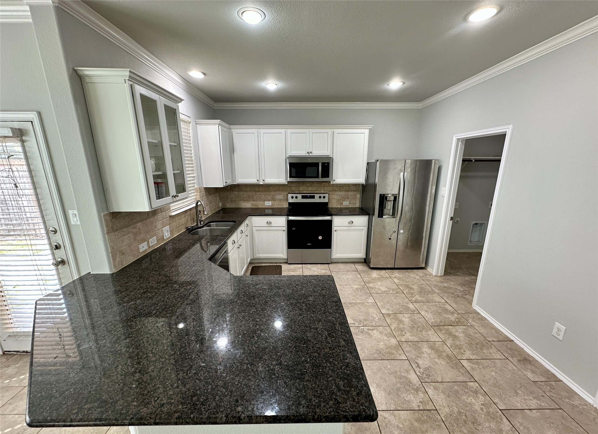 117 Chickadee Lane Leander, TX 78641 - Photo 3 of 24 a kitchen with stainless steel appliances granite countertop a refrigerator and a stove