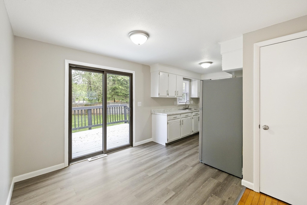 28 Bog Hollow Road Springfield, MA 01109 - Photo 6 of 19 a kitchen with a refrigerator a sink and dishwasher with wooden floor