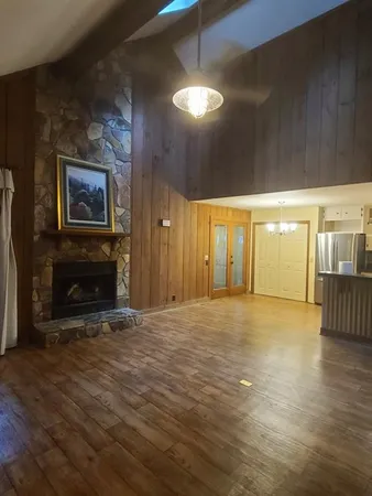 a view of an empty room with window and fireplace