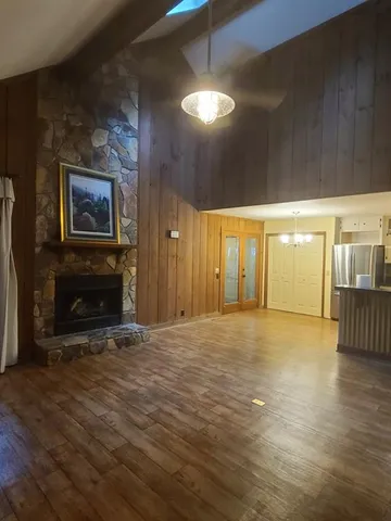 a view of an empty room with window and fireplace