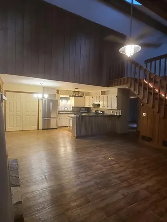 a view of a kitchen with stainless steel appliances wooden cabinets and a granite counter top