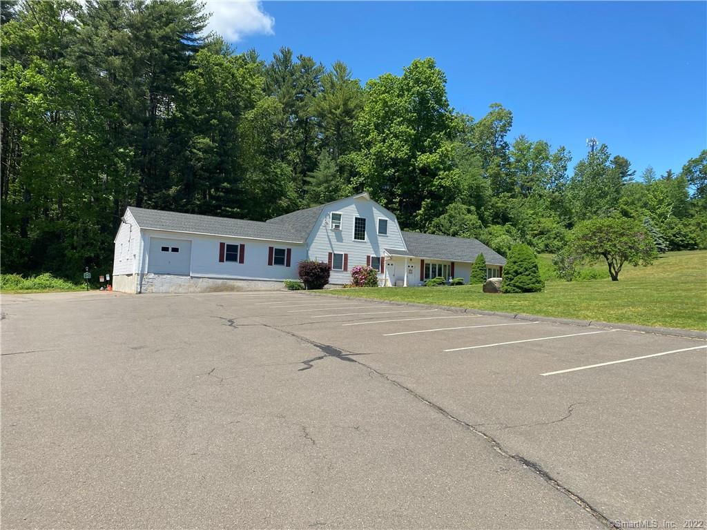 116 Stafford Road, Unit 1 Ellington, CT 06029 - Photo 1 of 1 a white house with a yard plants and large trees