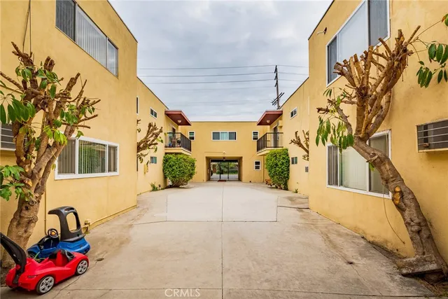 a view of a cars park in front of a building