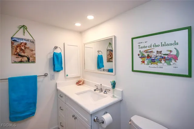 a bathroom with a sink mirror and toilet