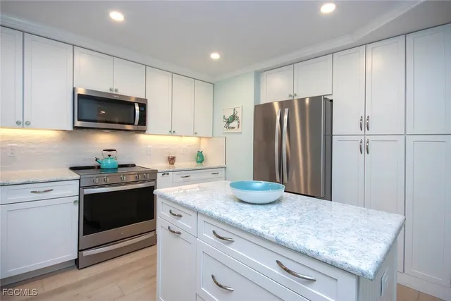 a kitchen with sink cabinets and stainless steel appliances