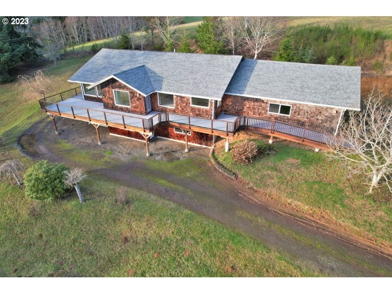 92831 Walluski Loop Astoria, OR 97103 - Photo 11 of 32 a aerial view of a house with swimming pool and a yard