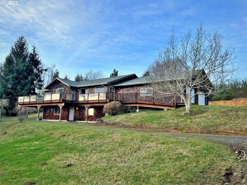 92831 Walluski Loop Astoria, OR 97103 - Photo 12 of 32 a view of a house with a backyard porch and sitting area