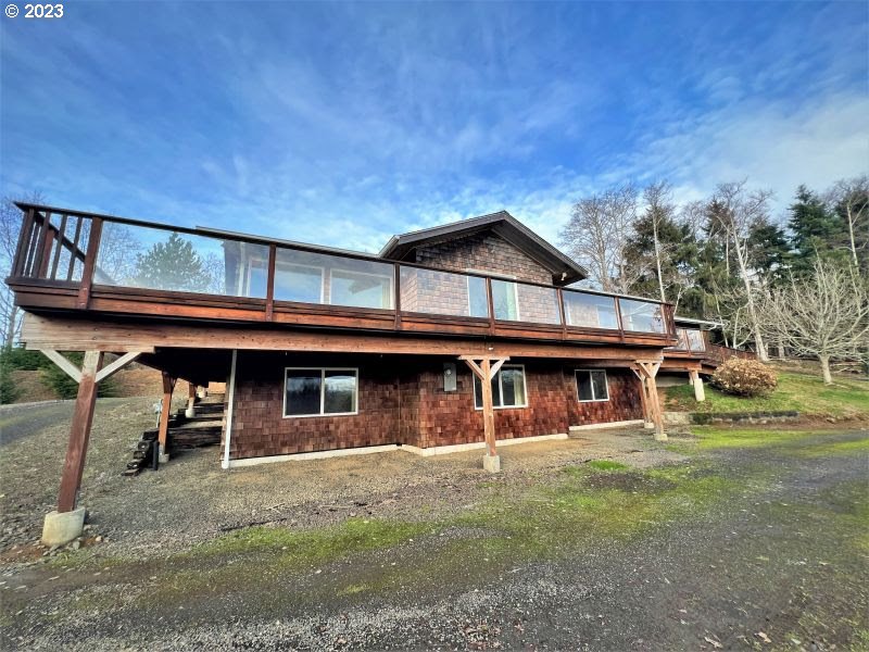 92831 Walluski Loop Astoria, OR 97103 - Photo 15 of 32 a front view of a house with garden