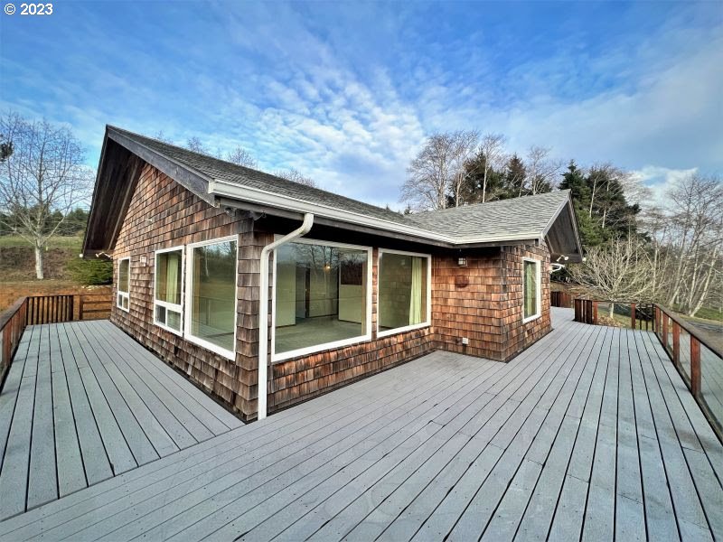 92831 Walluski Loop Astoria, OR 97103 - Photo 17 of 32 a view of backyard with a deck and wooden floor