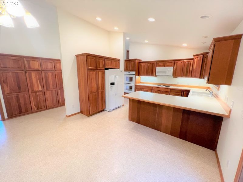 92831 Walluski Loop Astoria, OR 97103 - Photo 23 of 32 a kitchen with stainless steel appliances a refrigerator and a sink