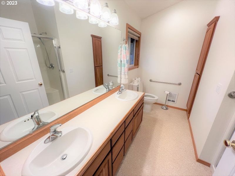 92831 Walluski Loop Astoria, OR 97103 - Photo 27 of 32 a spacious bathroom with a sink and a mirror