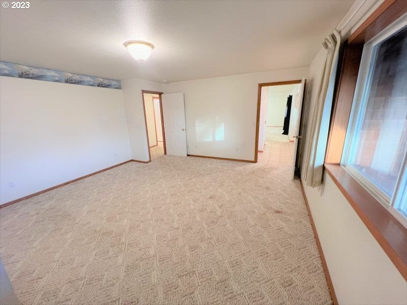 92831 Walluski Loop Astoria, OR 97103 - Photo 30 of 32 a view of a big room with closet and windows