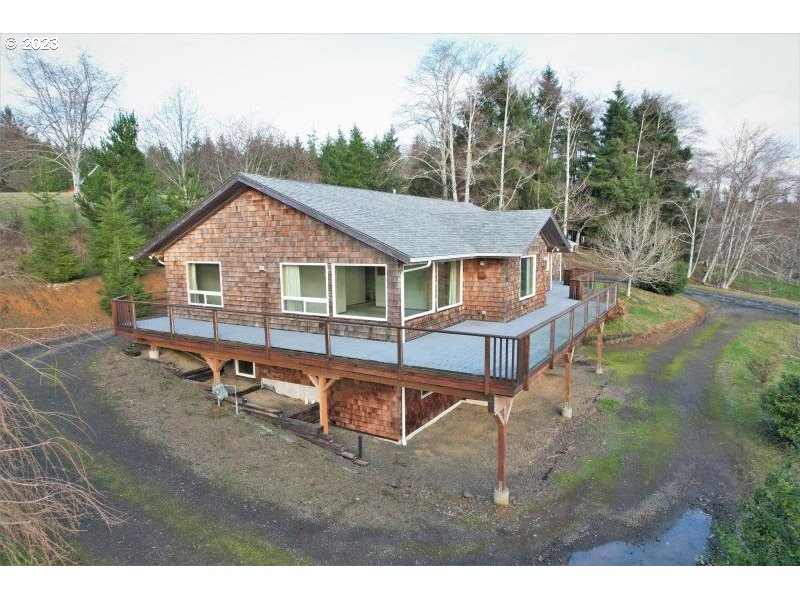 92831 Walluski Loop Astoria, OR 97103 - Photo 3 of 32 a view of a house with pool and chairs