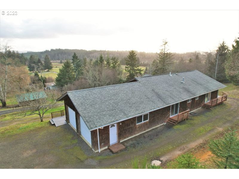 92831 Walluski Loop Astoria, OR 97103 - Photo 6 of 32 a view of a barn in the middle of a field