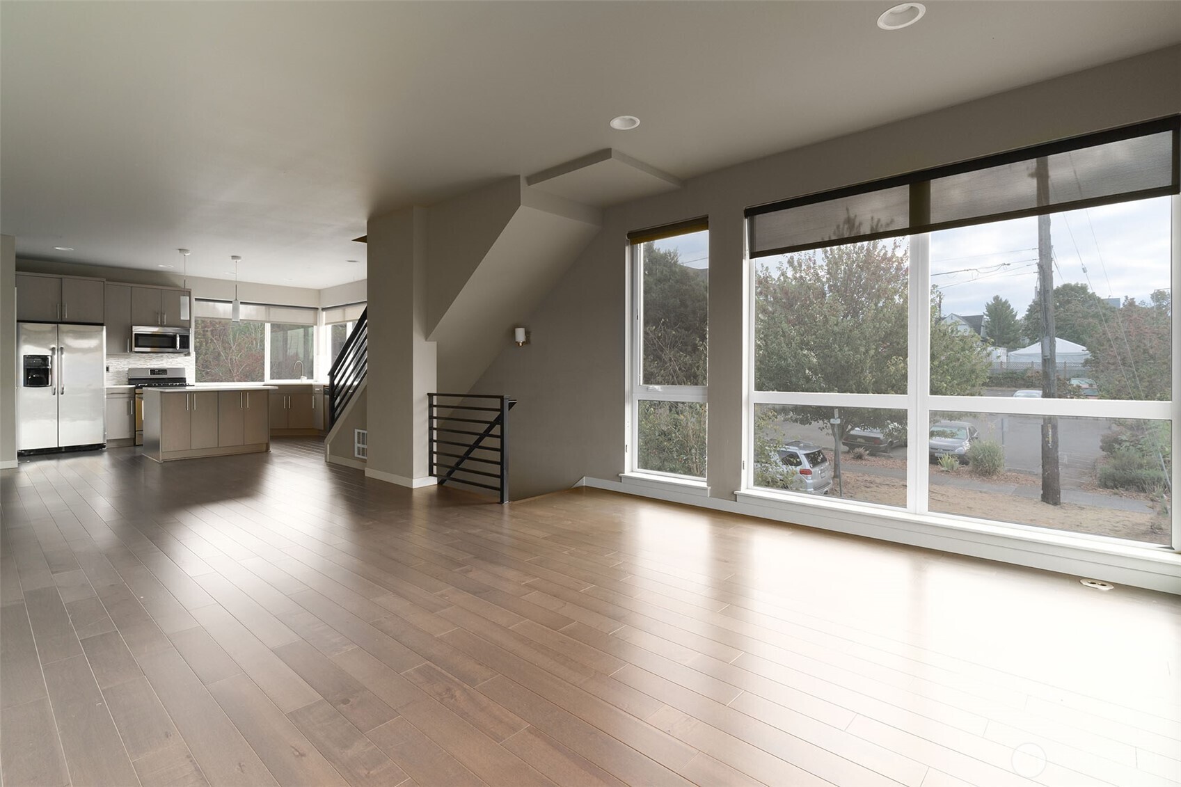 1626 East Yesler Way Seattle, WA 98122 - Photo 5 of 12 a view of an empty room with wooden floor and a window
