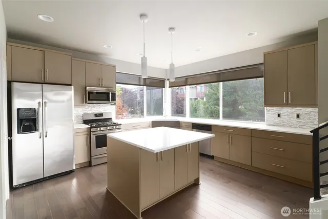 a kitchen with a stove a sink and a refrigerator