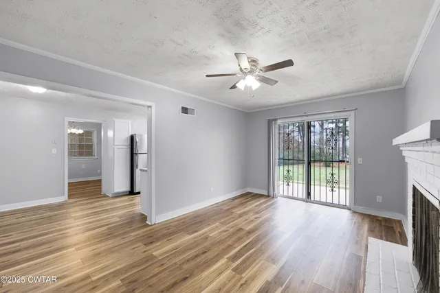 wooden floor fireplace and natural light in room