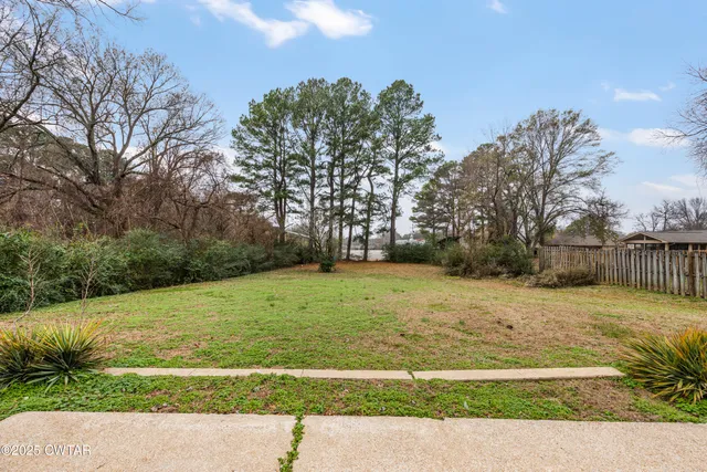 a view of an empty room and wooden floor