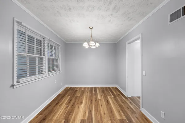 a kitchen with stainless steel appliances granite countertop white cabinets a refrigerator a sink a stove a microwave and island