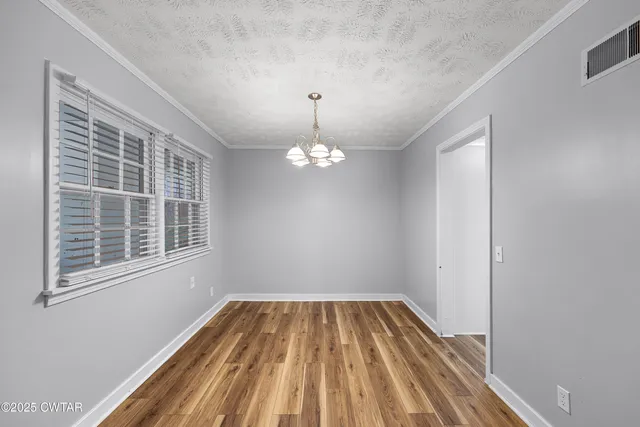 a kitchen with stainless steel appliances granite countertop white cabinets a refrigerator a sink a stove a microwave and island