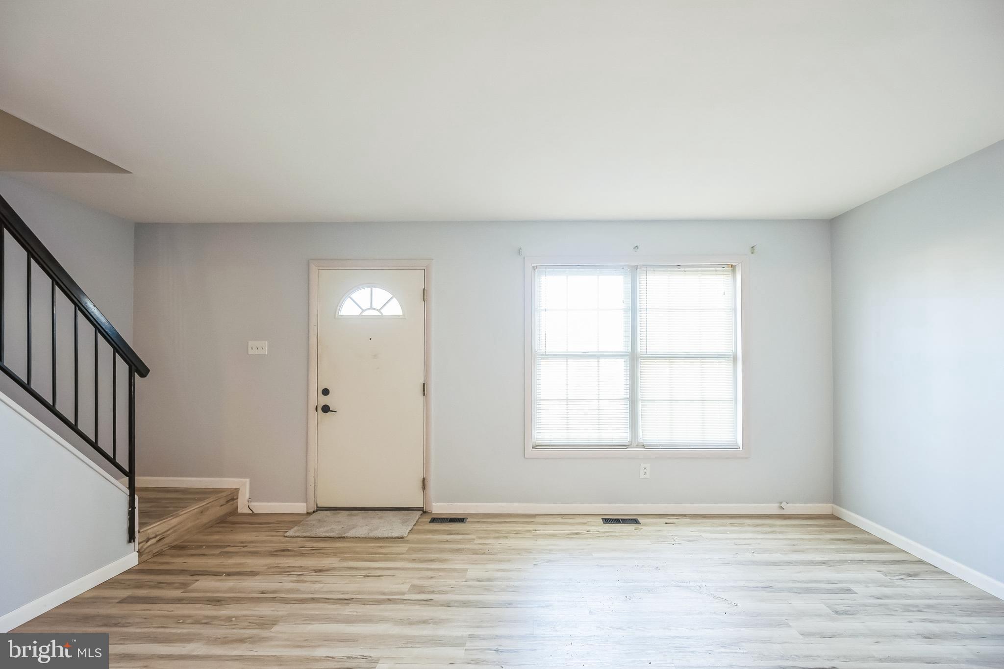 29 Maureen Court Sicklerville, NJ 08081 - Photo 2 of 14 an empty room with wooden floor and windows