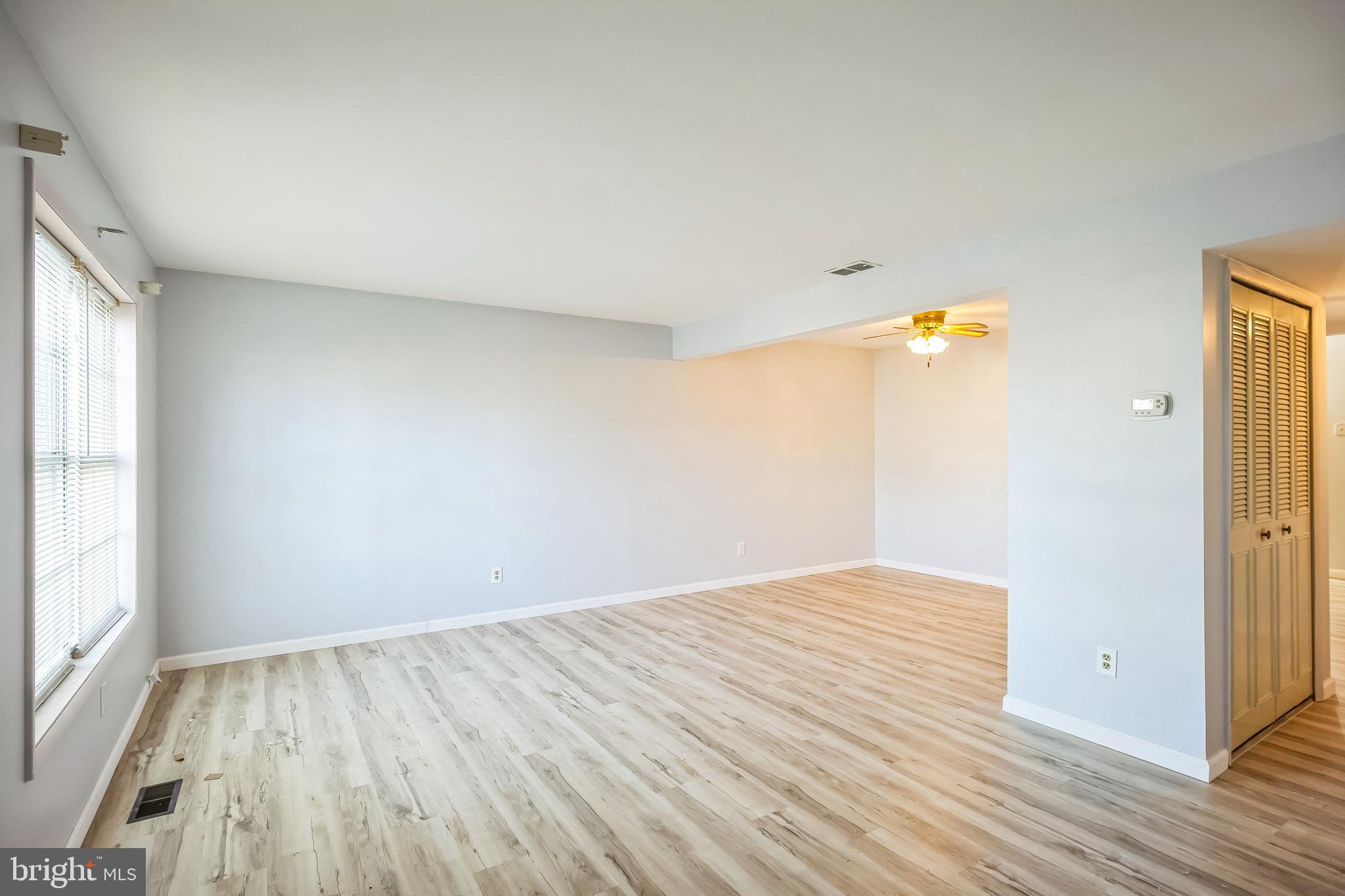 29 Maureen Court Sicklerville, NJ 08081 - Photo 3 of 14 an empty room with wooden floor and windows