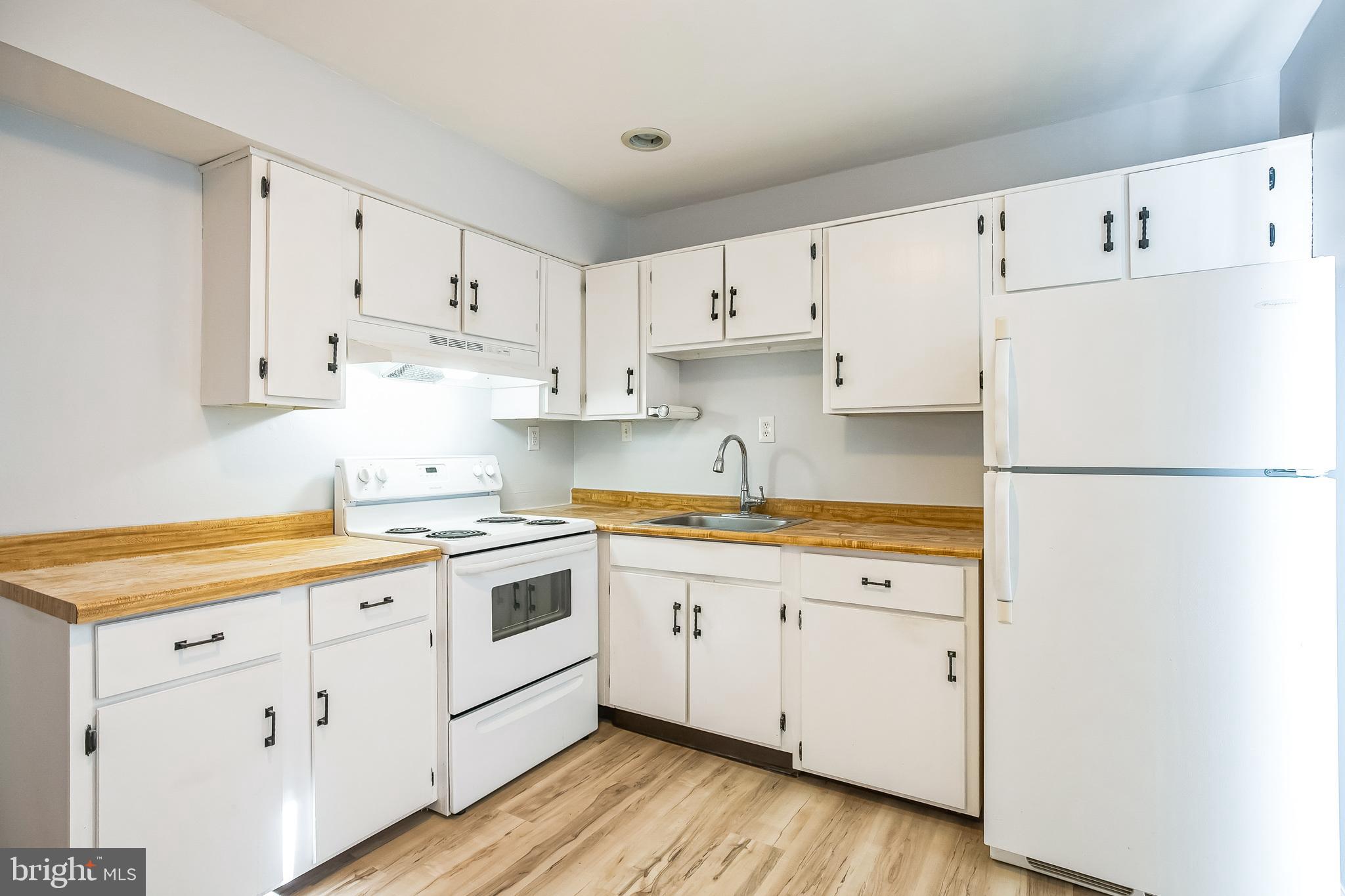 29 Maureen Court Sicklerville, NJ 08081 - Photo 7 of 14 a kitchen with cabinets appliances wooden floor and a window
