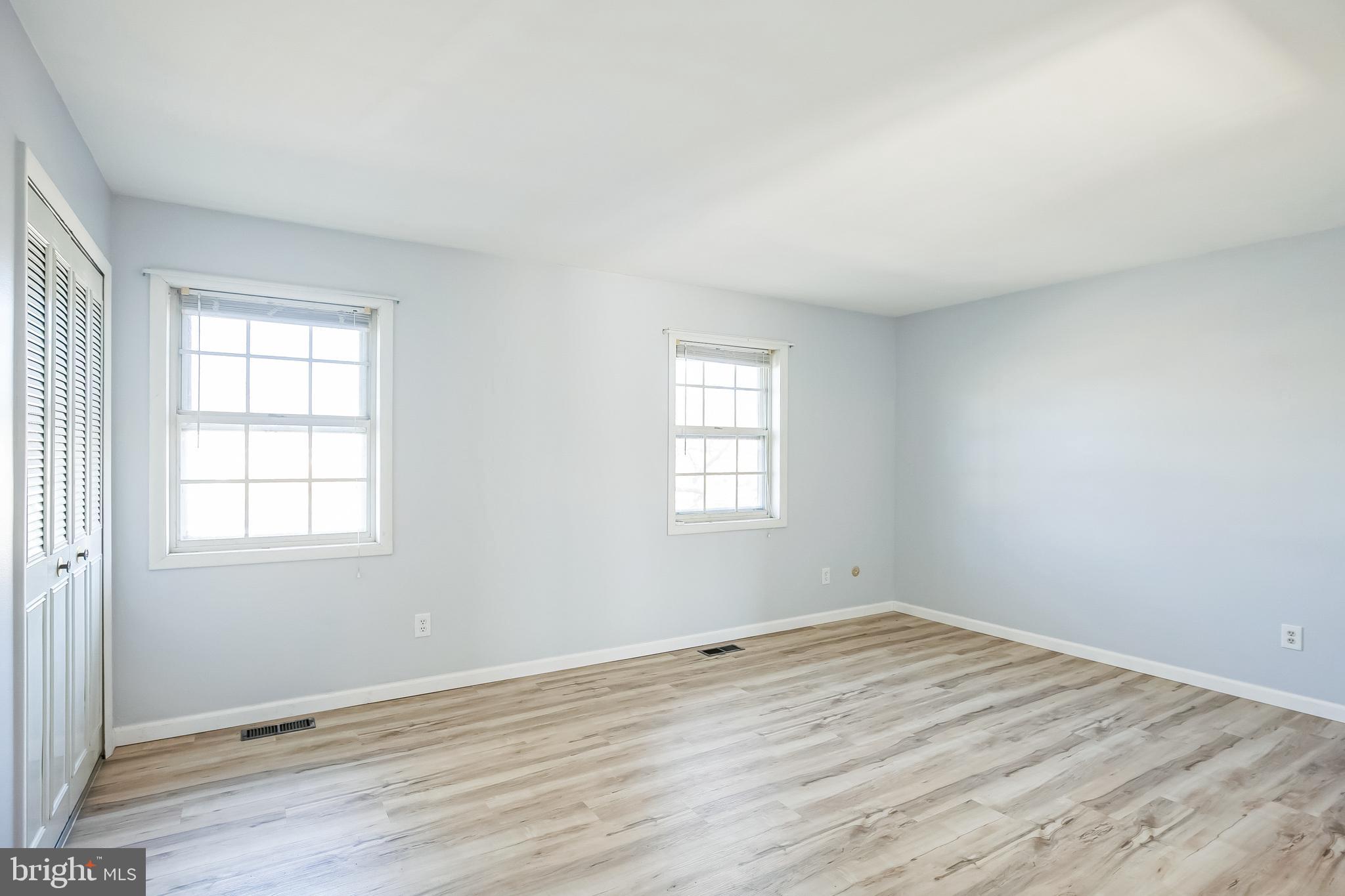 29 Maureen Court Sicklerville, NJ 08081 - Photo 8 of 14 an empty room with wooden floor and windows