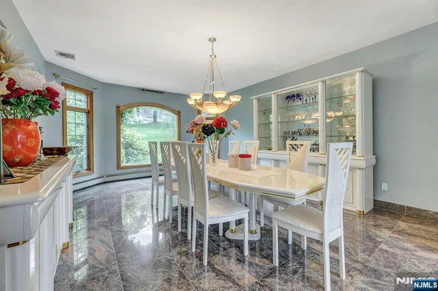 a dining room with furniture a chandelier and window