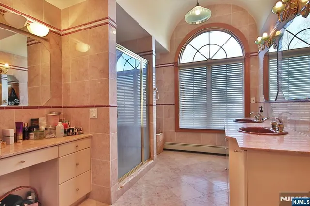 a bathroom with a sink a vanity and a mirror