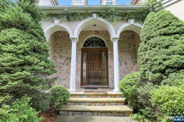 a view of building with front door and tree