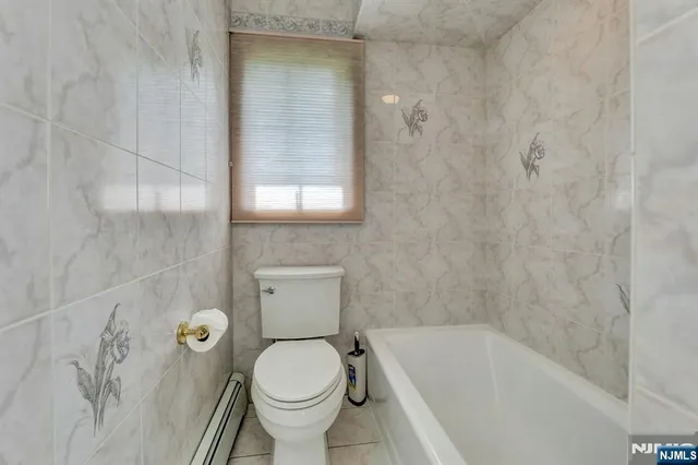 a bath room with a toilet and a bath tub