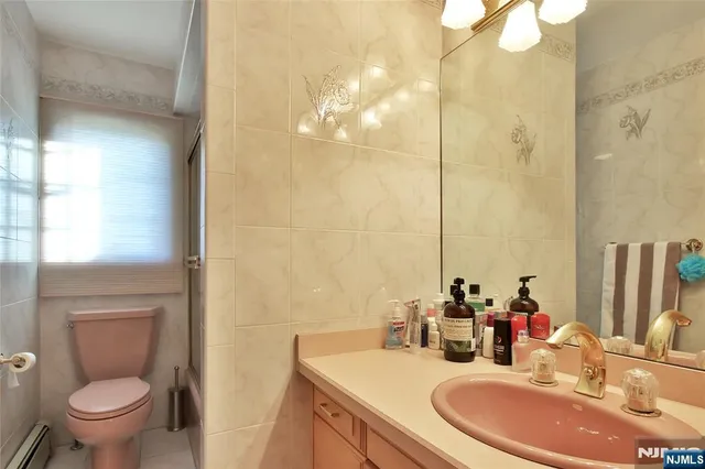 a bathroom with a sink a toilet and a mirror