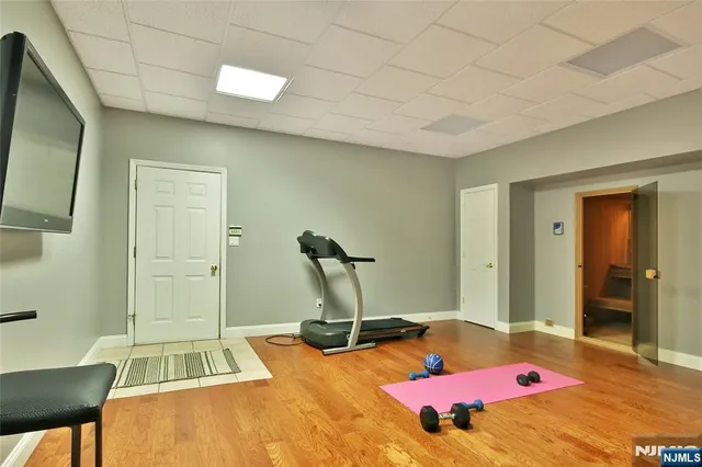 a room with gym equipment and a flat screen tv