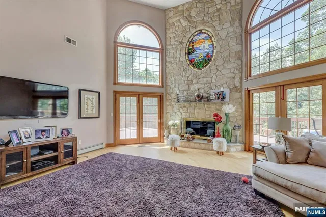 a living room with fireplace furniture and a flat screen tv