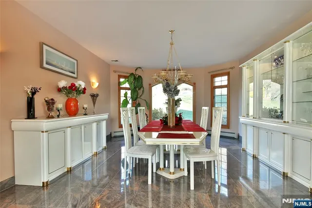 a dining room with furniture a chandelier and wooden floor