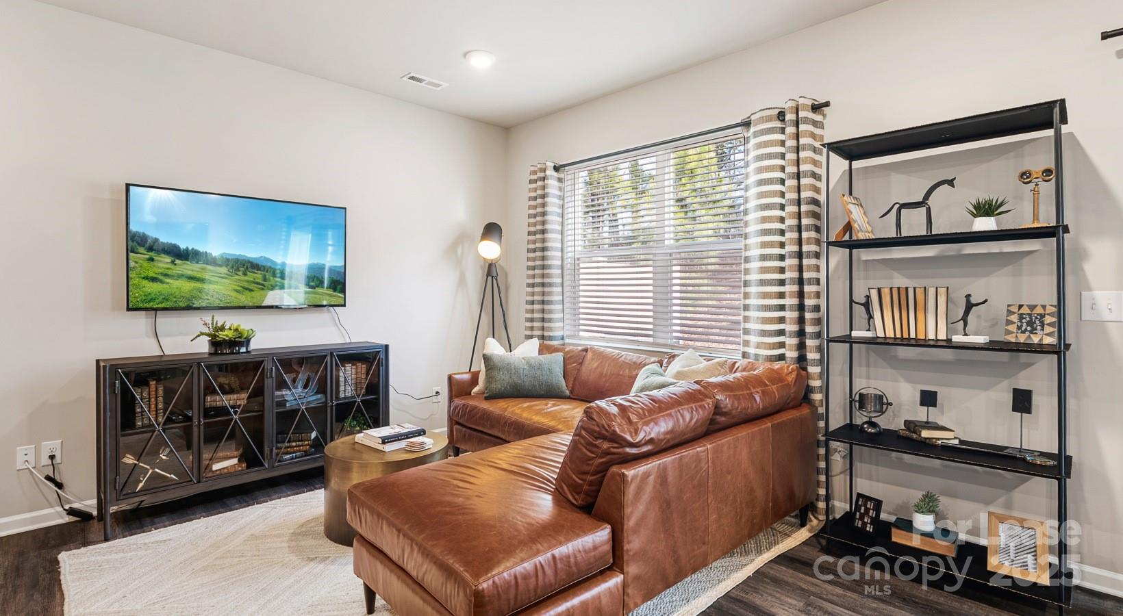525 Wayforth Road Northwest, Unit B3 Concord, NC 28027 - Photo 16 of 23 a living room with furniture and a flat screen tv