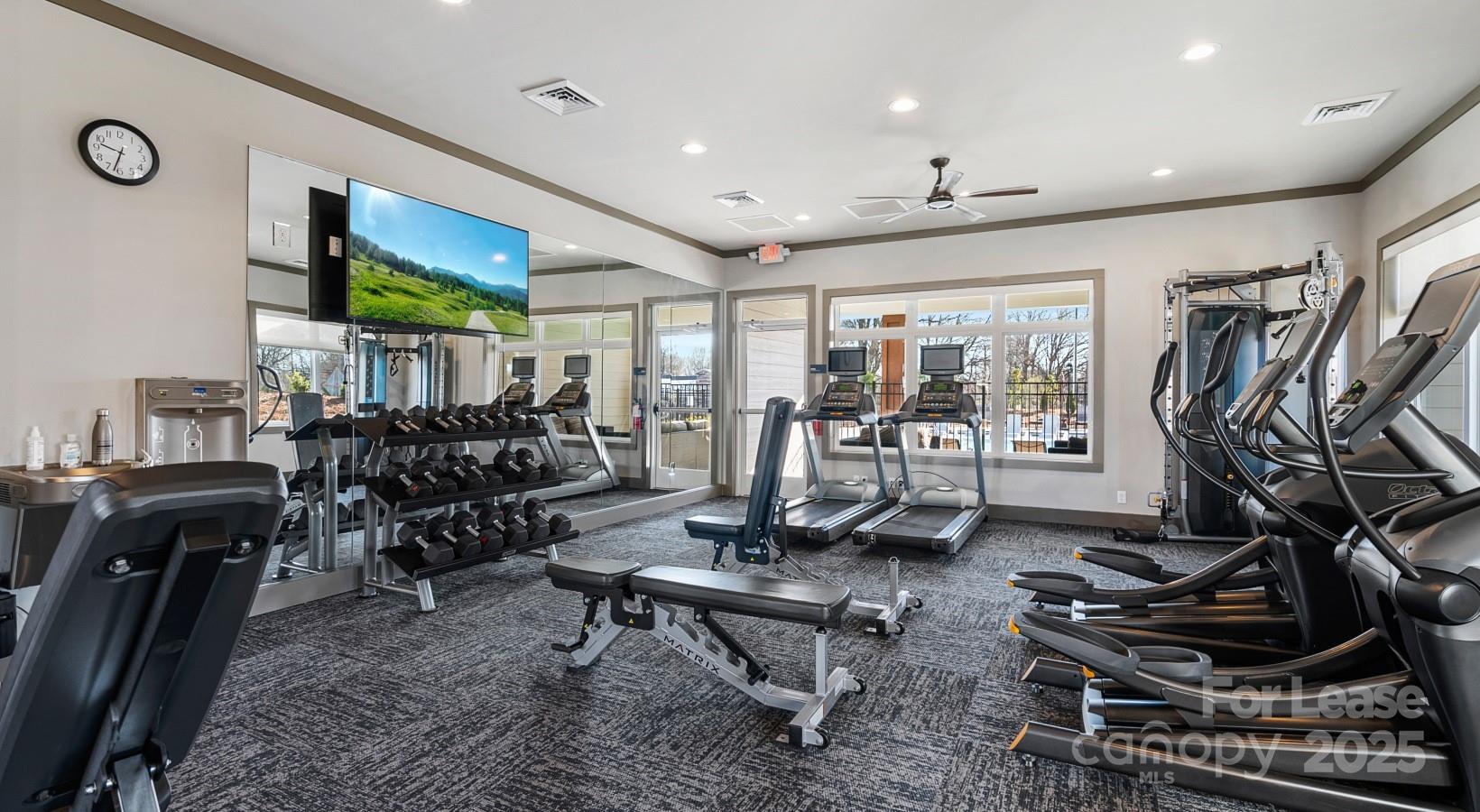 525 Wayforth Road Northwest, Unit B3 Concord, NC 28027 - Photo 10 of 23 a living room with lots of furniture and a flat screen tv