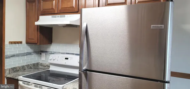 a kitchen with a refrigerator and cabinets