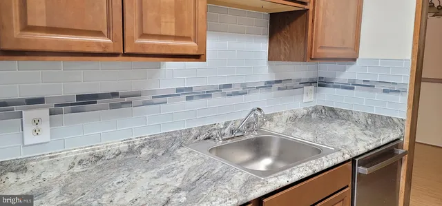 a kitchen with granite countertop a sink and a stove