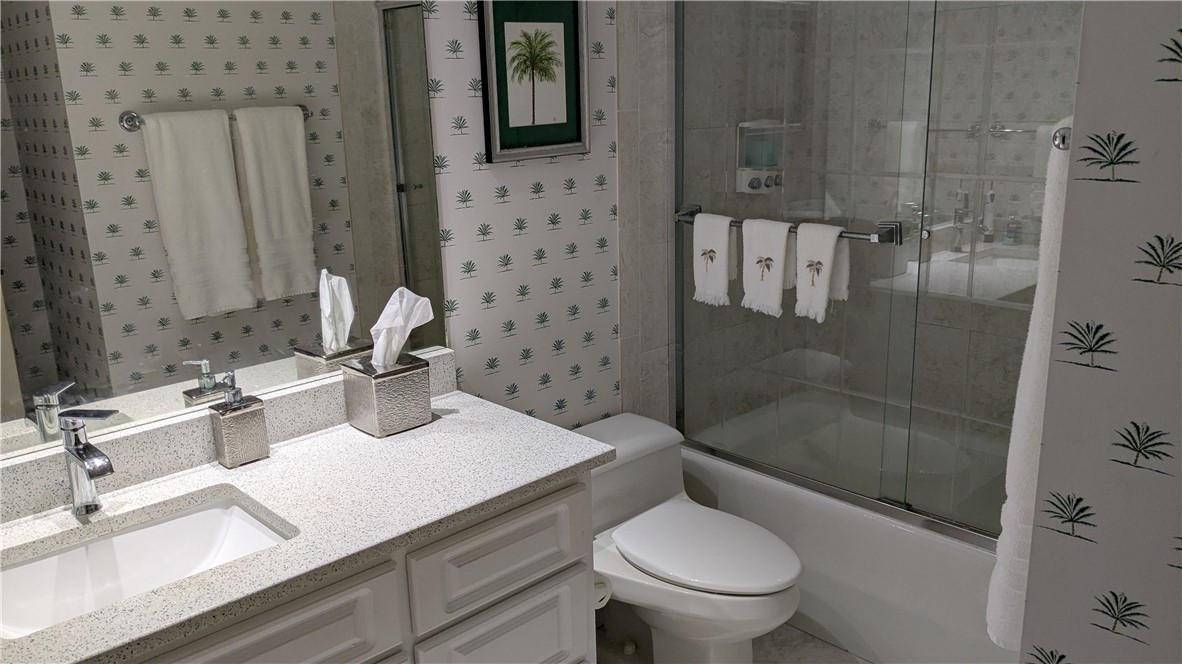 1903 Bay Road, Unit 206 Vero Beach, FL 32963 - Photo 12 of 30 a bathroom with a sink a toilet and shower