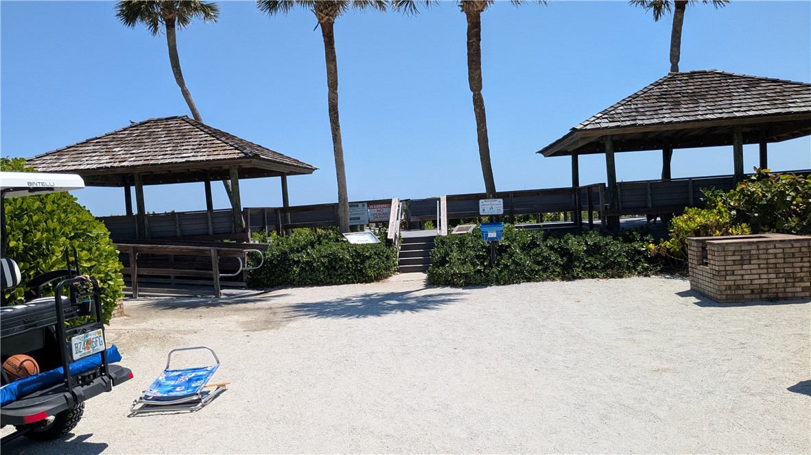 1903 Bay Road, Unit 206 Vero Beach, FL 32963 - Photo 14 of 30 a view of a table and chairs under an umbrella in patio