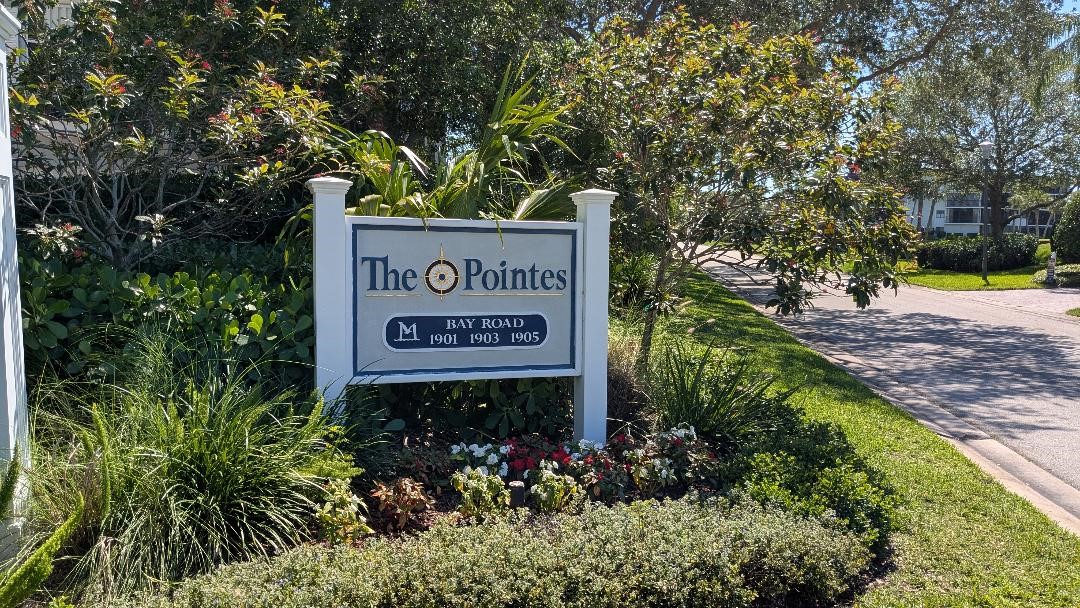 1903 Bay Road, Unit 206 Vero Beach, FL 32963 - Photo 17 of 30 a sign broad in front of flowers