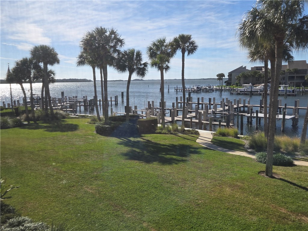 1903 Bay Road, Unit 206 Vero Beach, FL 32963 - Photo 19 of 30 a view of a lake with a garden and trees
