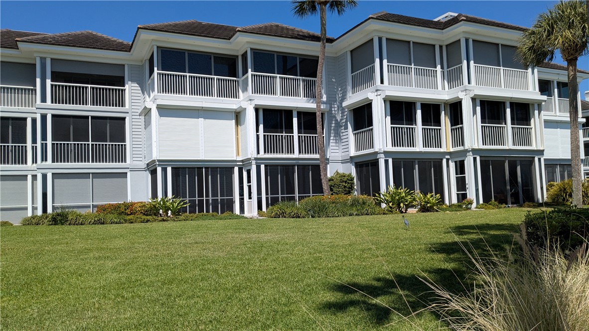1903 Bay Road, Unit 206 Vero Beach, FL 32963 - Photo 2 of 30 a view of building with yard