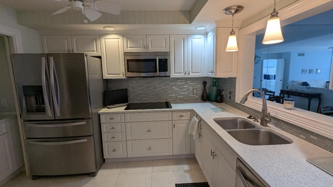 1903 Bay Road, Unit 206 Vero Beach, FL 32963 - Photo 3 of 30 a kitchen with a sink cabinets and stainless steel appliances