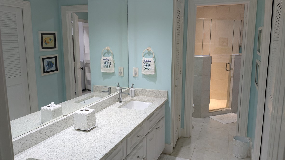 1903 Bay Road, Unit 206 Vero Beach, FL 32963 - Photo 5 of 30 a bathroom with a sink and a mirror