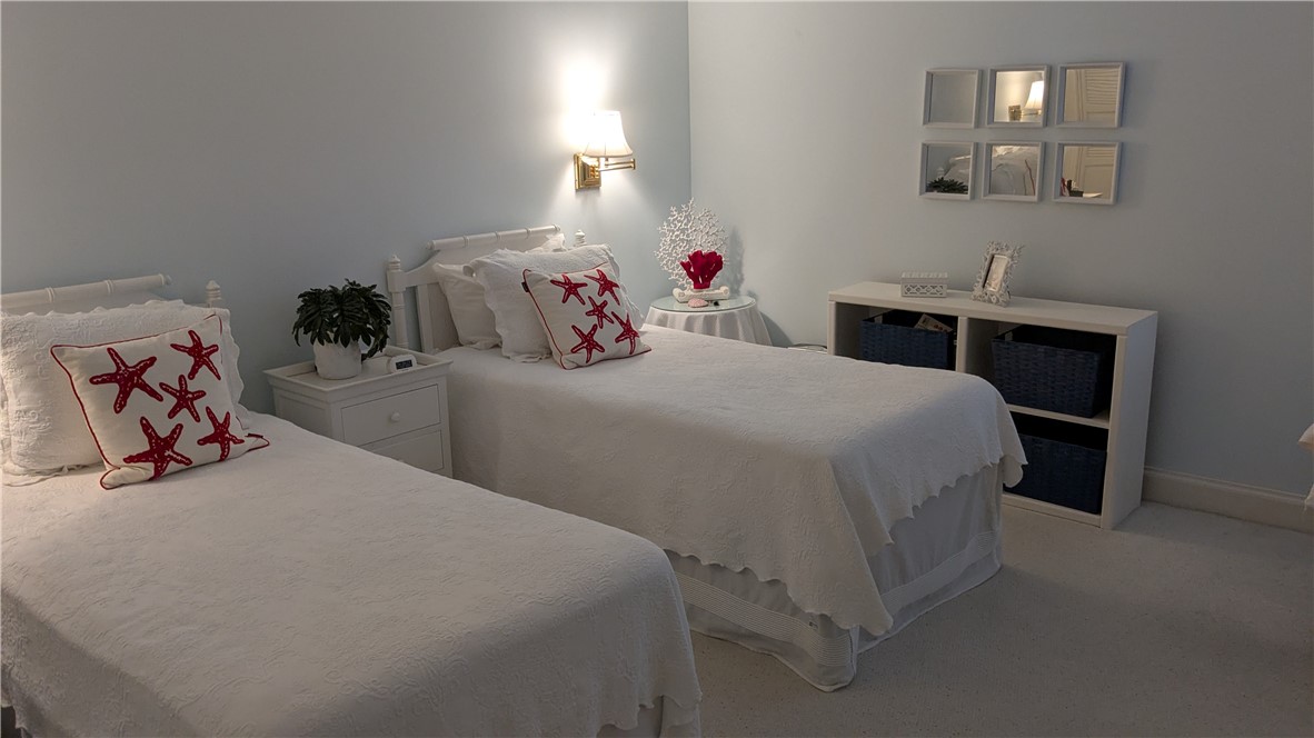 1903 Bay Road, Unit 206 Vero Beach, FL 32963 - Photo 6 of 30 a bedroom with a bed and a lamp on dresser